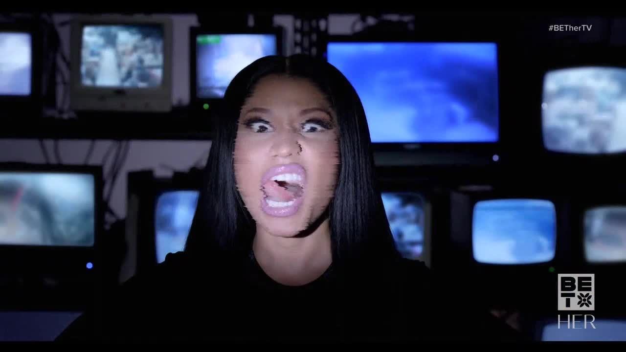 Her face is contorted, mouth agape, as if she's screaming at the camera. Behind her, a wall of old televisions flickers with static and images, a backdrop for the BET Her promo.
