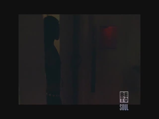 A figure stands in silhouette, framed by dark walls, with a red light glowing faintly in the distance. The BET Soul logo sits in the corner, a sign of a late-night show.
