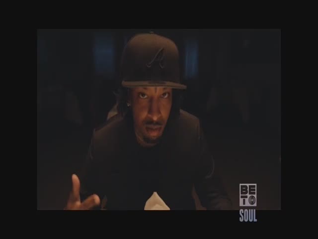 A man in a black cap and jacket gestures with his hands, looking directly at the camera. The BET Soul logo is visible in the lower right corner.
