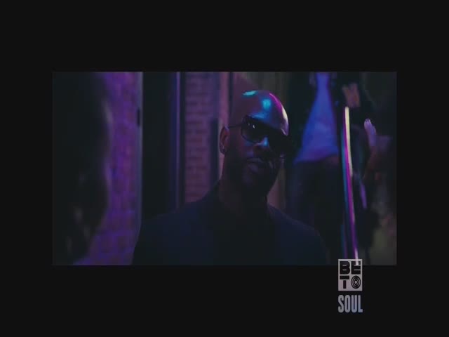 A man in sunglasses stares directly at the camera, illuminated by purple light. The BET Soul logo is visible at the bottom right.
