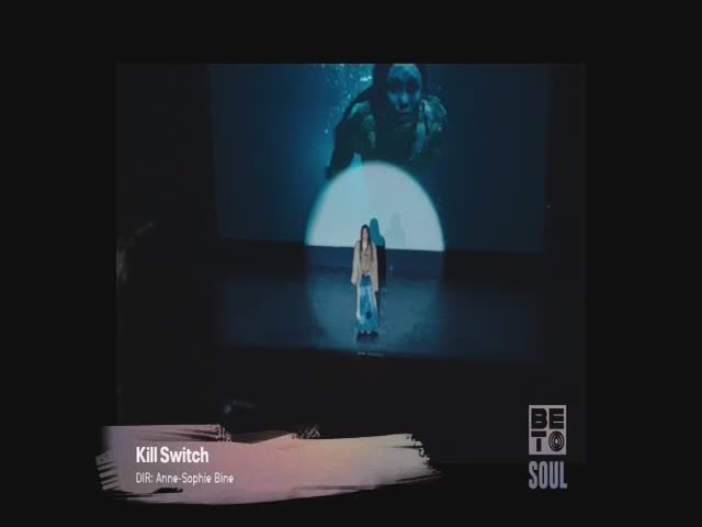 A woman stands alone on a stage, bathed in a spotlight, as a shadowy image of a person underwater looms behind her. The BET Soul logo is visible, and the title card for "Kill Switch" appears at the bottom.
