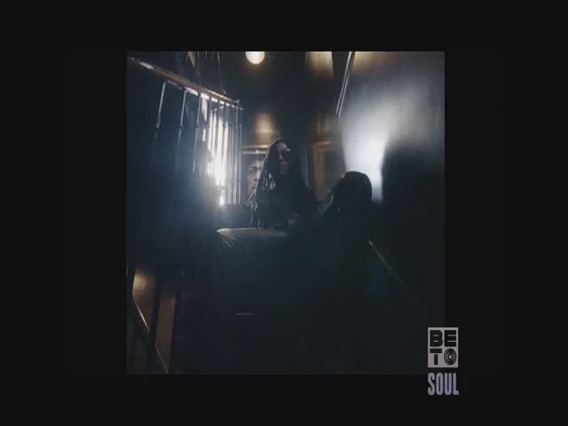 A woman with long hair is standing at the top of a staircase, looking down. The scene is dimly lit, with a BET Soul logo in the corner.
