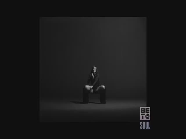 A woman in dark clothing sits on the floor, her head resting on her hand. The BET Soul logo sits in the bottom right corner.
