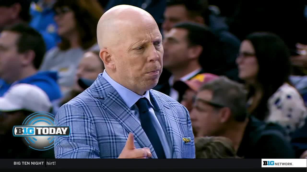 The man in the blue plaid suit is gesturing with his right hand, his thumb up. He's on the Big Ten Network, probably commenting on a game.
