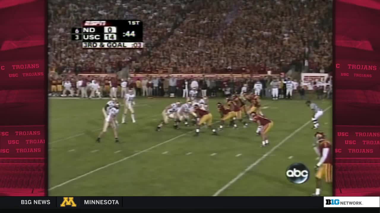 The USC Trojans are lined up on offense, ready for a play near the goal line. Notre Dame's defense is set, with the clock ticking down in the first quarter of this Big Ten Network broadcast.
