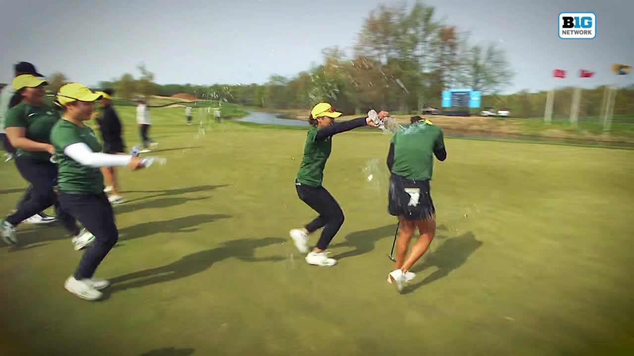A golfer is being sprayed with water as teammates celebrate a victory on the green. The Big Ten Network logo is visible in the top right corner.
