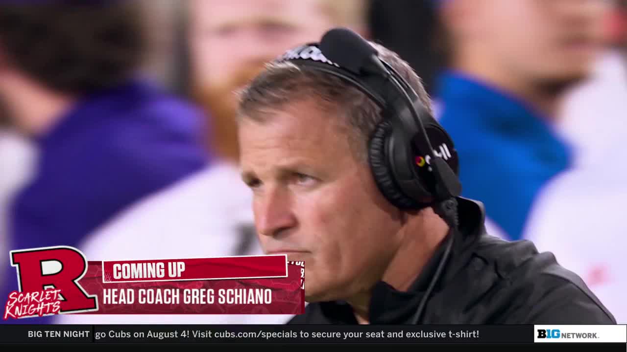 Head Coach Greg Schiano is focused, wearing a headset as he looks to the side. The Big Ten Network graphic identifies the coach and the Rutgers Scarlet Knights.
