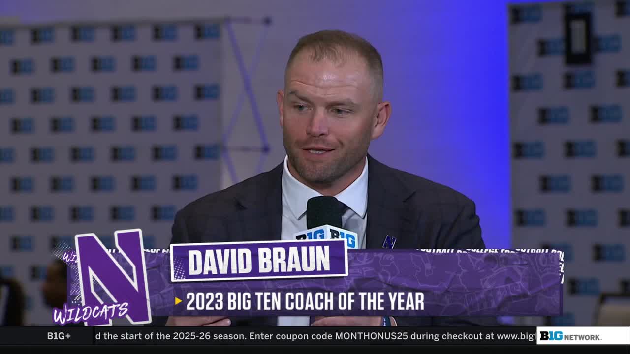 David Braun, the Northwestern Wildcats coach, is seated and speaking into a microphone. A graphic on the Big Ten Network identifies him as the 2023 Big Ten Coach of the Year.
