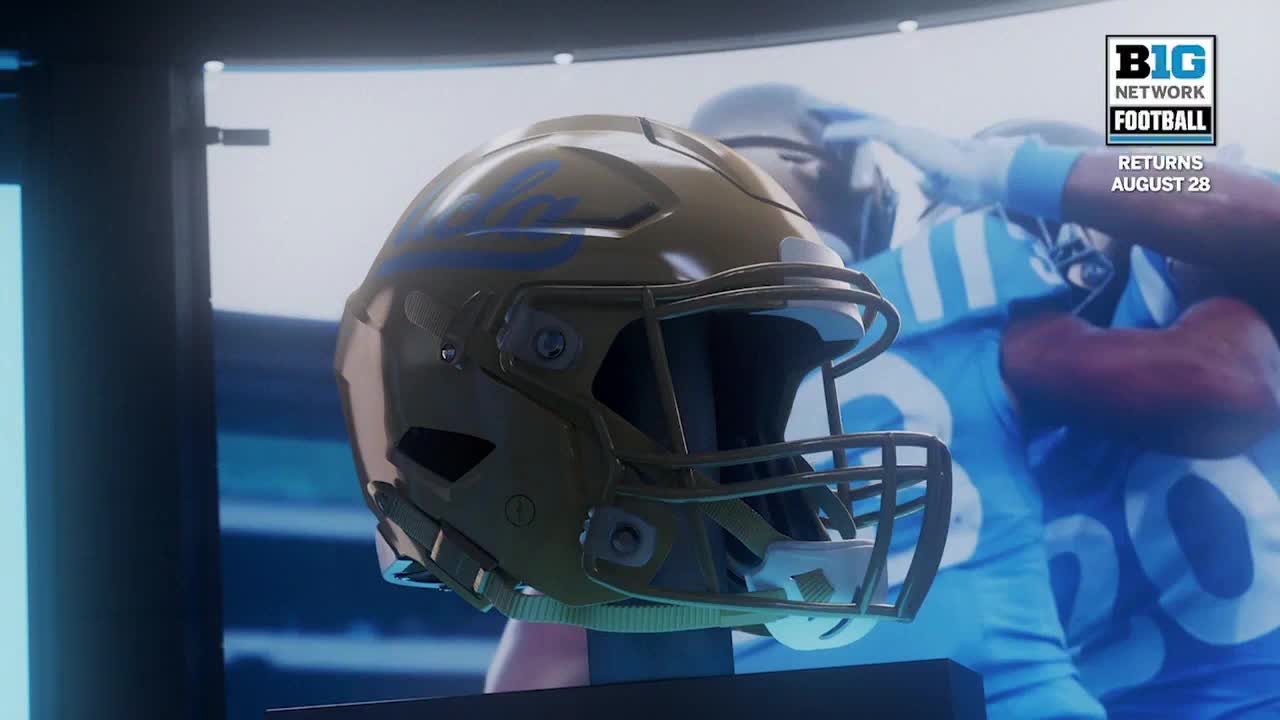 A gold football helmet, emblazoned with blue lettering, sits prominently in the foreground. Behind it, a screen displays a Big Ten Network football game, promising the return of the sport on August 28th.

