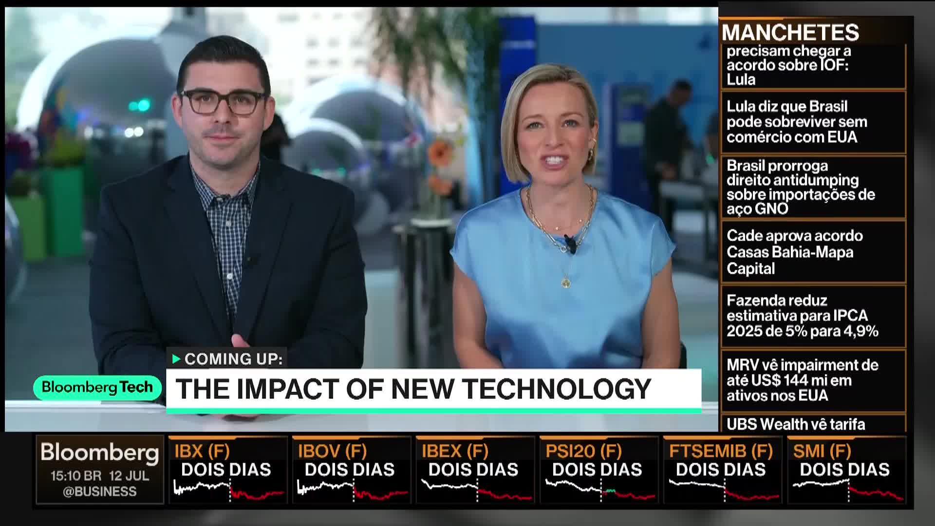 Two presenters on Bloomberg Tech are looking directly at the camera, discussing "The Impact of New Technology." A news ticker runs along the bottom, and a sidebar with financial headlines is visible on the right.
