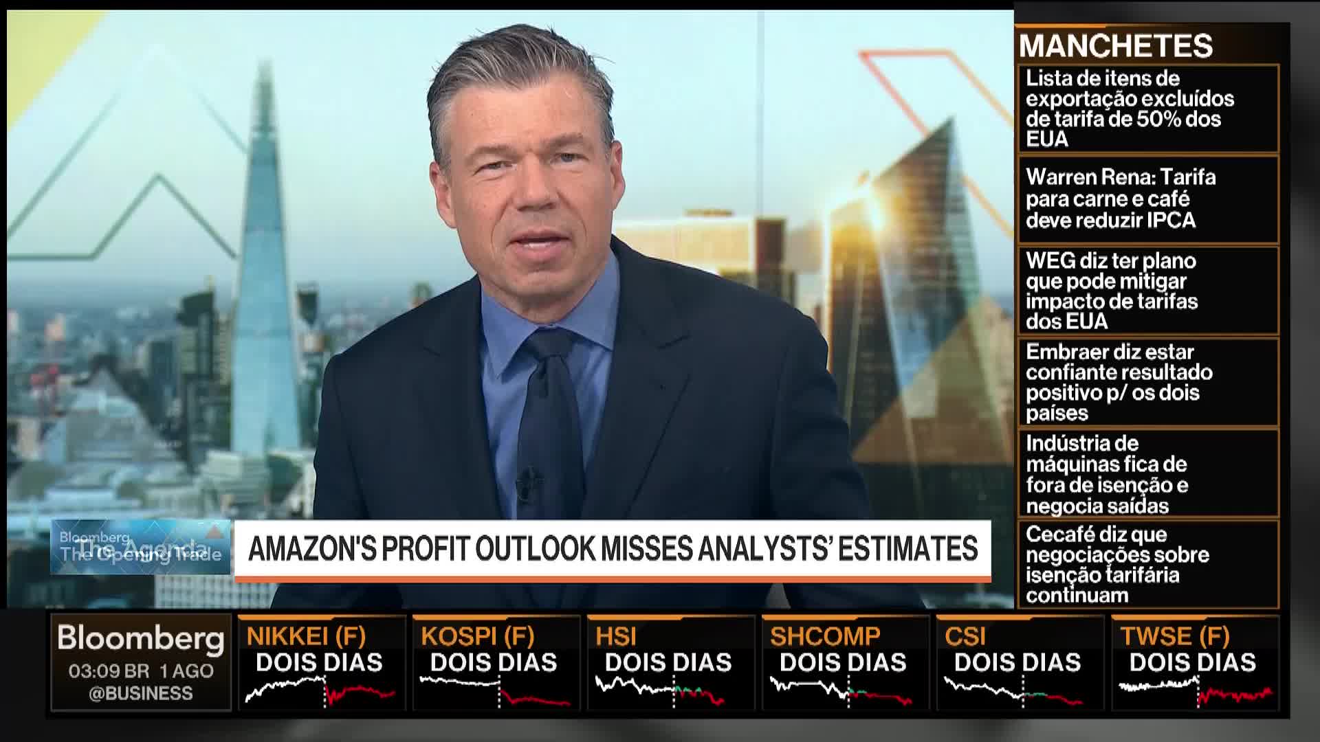 A man in a suit, likely on Bloomberg TV, is speaking directly to the camera. Behind him, a graphic displays the headline "Amazon's Profit Outlook Misses Analysts' Estimates" along with market data.
