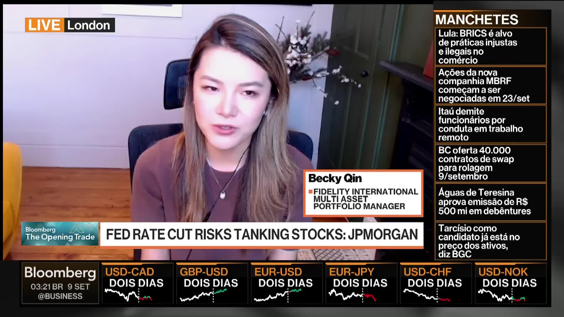 Becky Qin, a portfolio manager, is speaking directly to the camera on Bloomberg TV from London. The screen displays financial news headlines and currency exchange rates below her.

