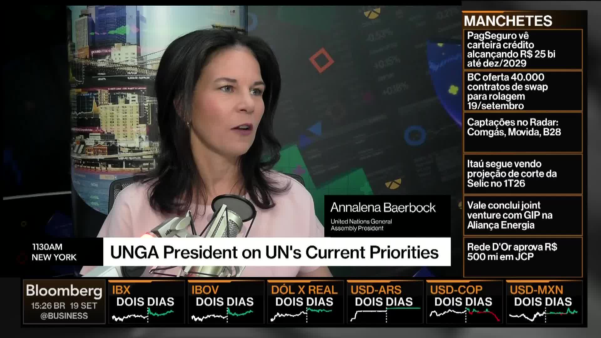 Annalena Baerbock, the UNGA President, is speaking on Bloomberg TV. A ticker with financial news scrolls along the bottom of the screen.
