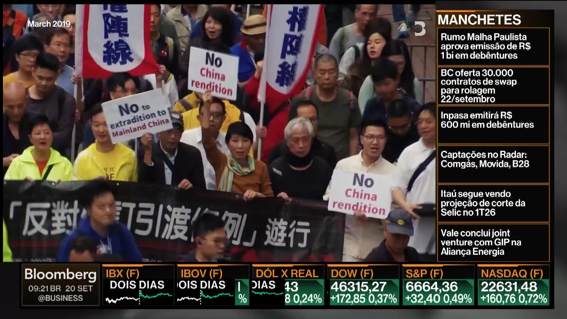 A crowd of people marches, holding signs that read "No China rendition" and "No to extradition to Mainland China." A woman in the front raises her arm, and a Bloomberg TV graphic appears in the corner.
