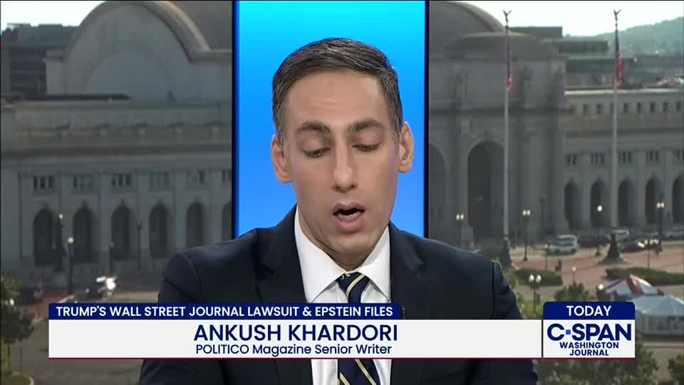 A man in a suit and tie speaks directly to the camera, his mouth open as he delivers a report. The C-SPAN logo and a Washington, D.C. backdrop are visible behind him.
