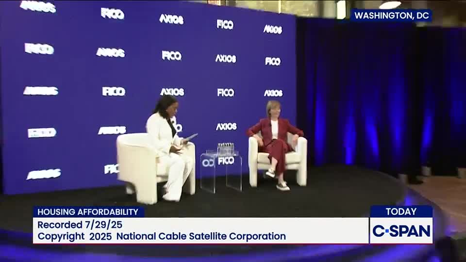 Two women are seated in armchairs on a stage, facing each other. The backdrop is a deep blue with logos, and a C-SPAN logo is visible in the lower right corner.
