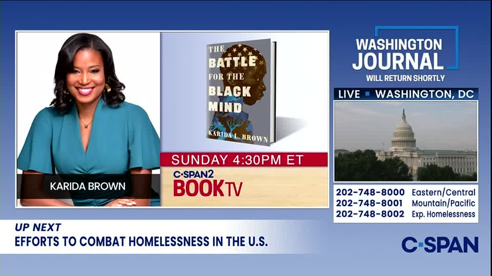Karida Brown smiles from a screen on C-SPAN2, promoting her book, "The Battle for the Black Mind." The Washington Journal logo and a view of the Capitol building are visible, with a segment on homelessness in the U.S. scheduled next.
