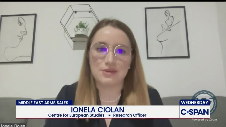 A woman with glasses is speaking, her image framed on a C-SPAN broadcast. The lower third of the screen identifies her as Ionela Ciolan, a research officer.
