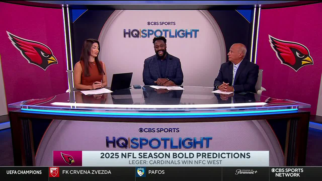 Three people sit behind a desk on the CBS Sports Network USA set, discussing the upcoming NFL season. The show, "HQ Spotlight," is focused on bold predictions, with the Cardinals' potential win in the NFC West highlighted.
