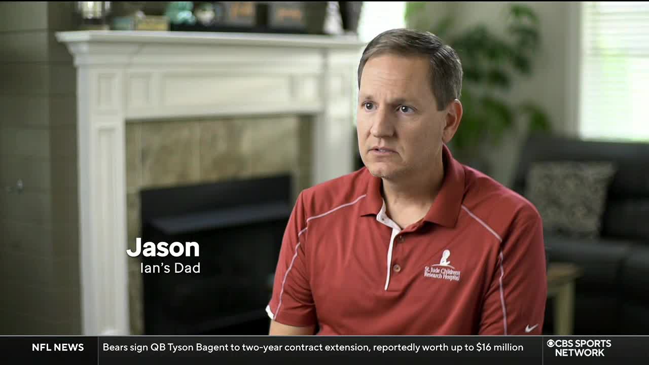 A man named Jason, identified as "Ian's Dad," is speaking on camera. He's wearing a red polo shirt and sitting in front of a fireplace, as seen on CBS Sports Network USA.
