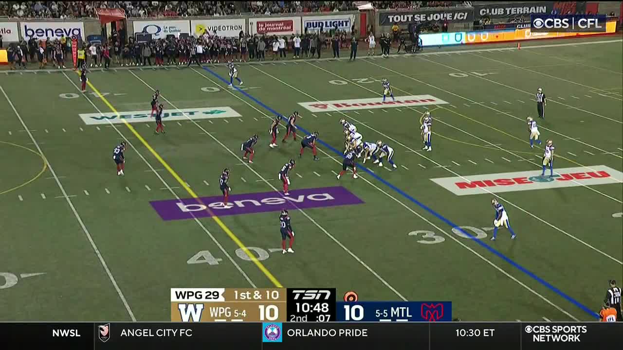 The Winnipeg Blue Bombers are on offense, lined up at the 40-yard line. The Montreal Alouettes defense is ready, with players poised to make a play.
