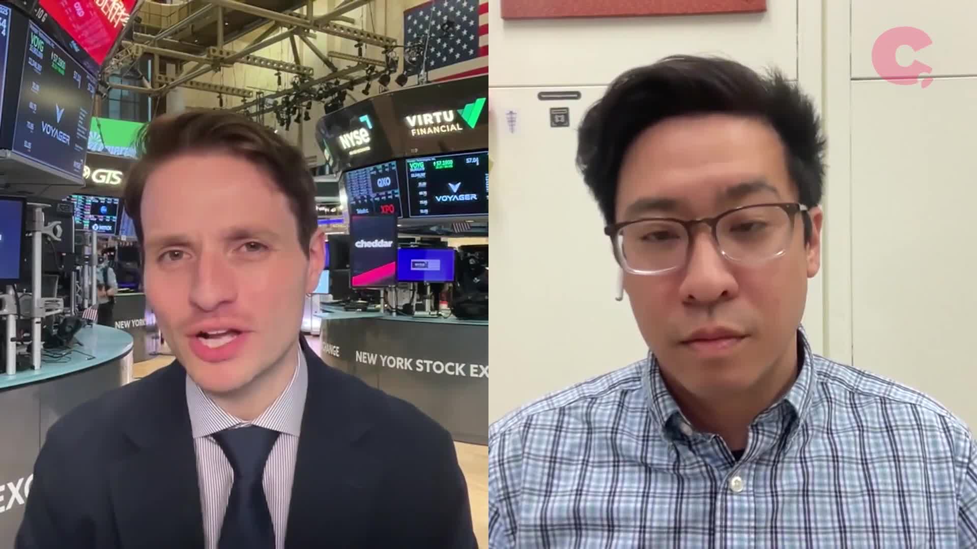 A man in a suit speaks from the floor of the New York Stock Exchange, with screens displaying stock information behind him. Across the screen, another man in glasses listens intently, likely participating in a Cheddar News segment.
