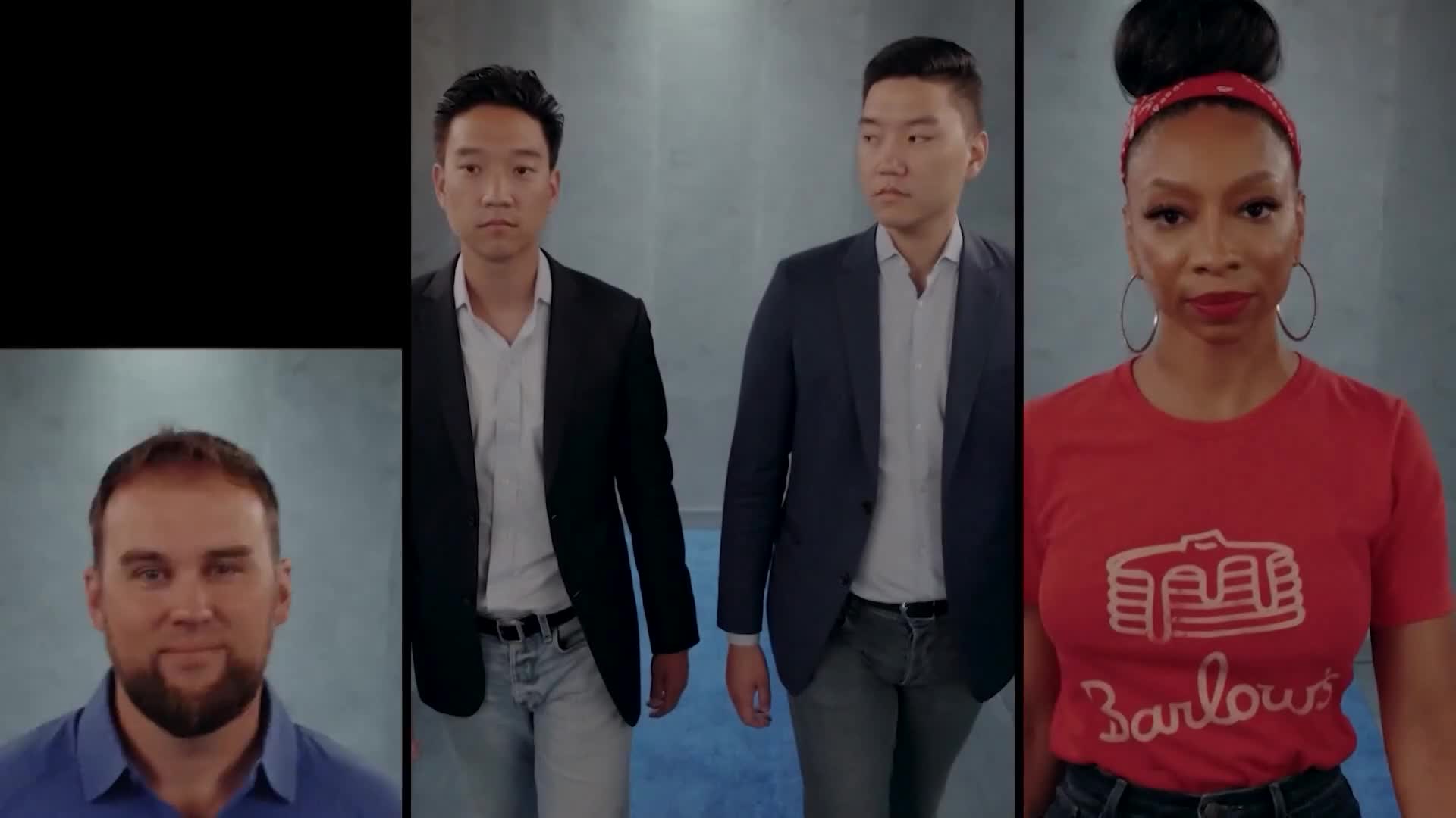 Two men in suits walk toward the camera, while a woman in a red shirt with a pancake logo stands to the right. A man with a beard is on the left.
