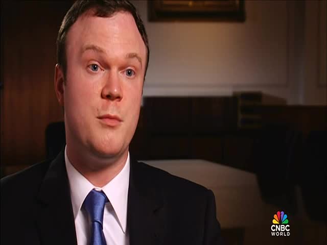 A man in a dark suit and blue tie is looking directly at the camera, his expression neutral. The CNBC World logo is visible in the corner, suggesting a broadcast from the United States.
