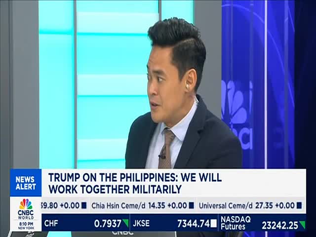 The CNBC World anchor is speaking, his gaze directed off-camera. A headline about Trump and the Philippines scrolls across the bottom of the screen.
