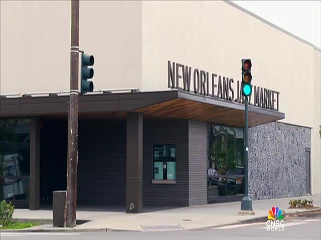 The traffic light is green, and the sign above the entrance reads "NEW ORLEANS JAZZ MARKET." A CNBC World logo sits in the corner.
