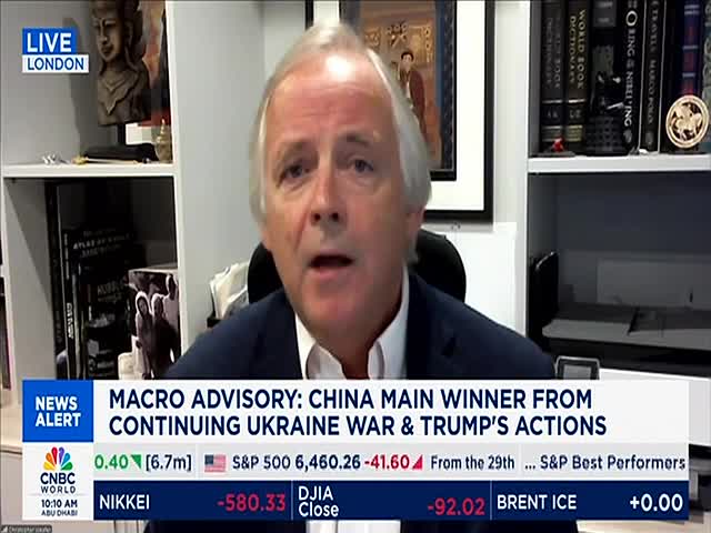 A man in a dark suit is speaking, his mouth open as he addresses the camera. Below him, the CNBC World ticker displays market data and a headline about China.
