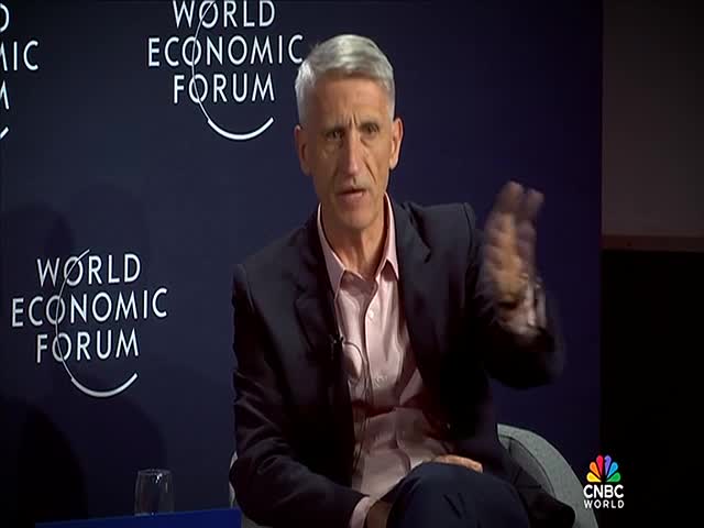 The man in the suit gestures with his right hand, the fingers a bit blurred from the movement. He's seated in front of a dark backdrop with the World Economic Forum logo, as CNBC World's logo sits in the corner.
