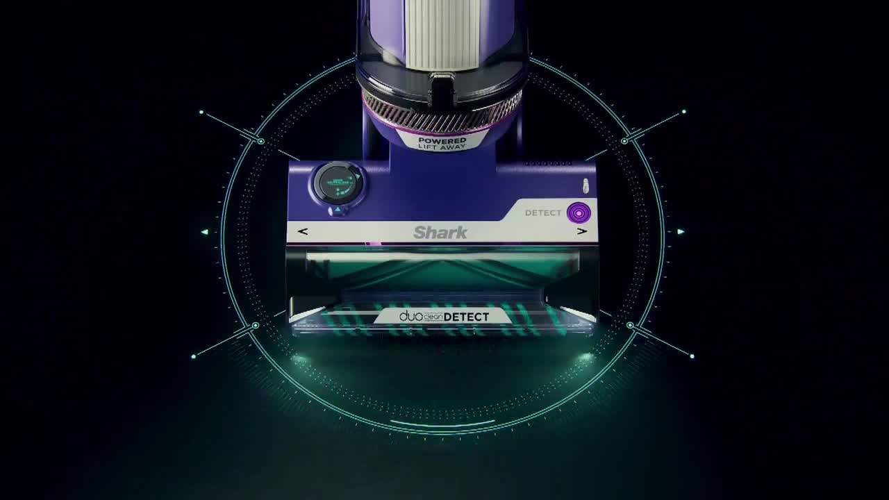 A purple and black vacuum cleaner is centered against a dark background, with a green-lit circular graphic around it. The vacuum's brush head is visible, and the "Shark" logo is displayed prominently.
