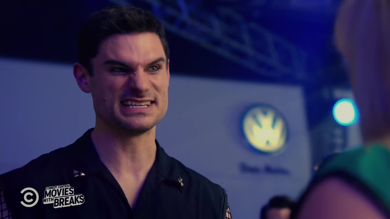 The man is glaring, his teeth bared, and his dark eyes narrowed. A Comedy Central logo is visible, suggesting this is a scene from a show.
