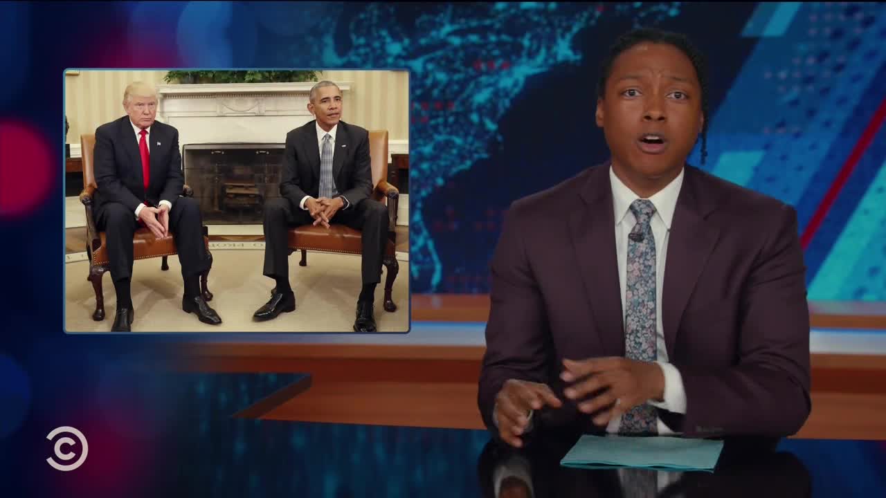 A man in a suit is speaking directly to the camera, gesturing with his hands. In the corner, a split screen shows two former U.S. presidents seated in a room.
