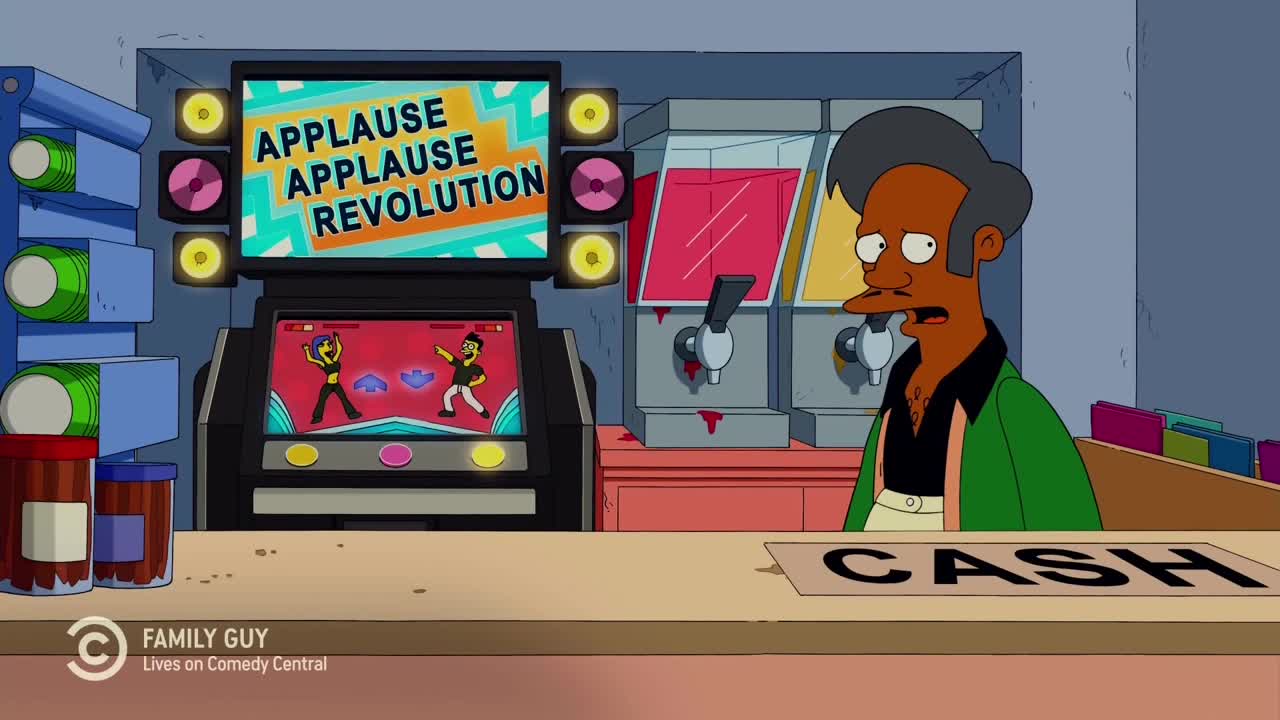 Apu stands behind the counter, looking bewildered, as a "Applause Applause Revolution" arcade game blares from the screen. The game itself shows animated figures dancing, while the machine is flanked by speakers and lights.
