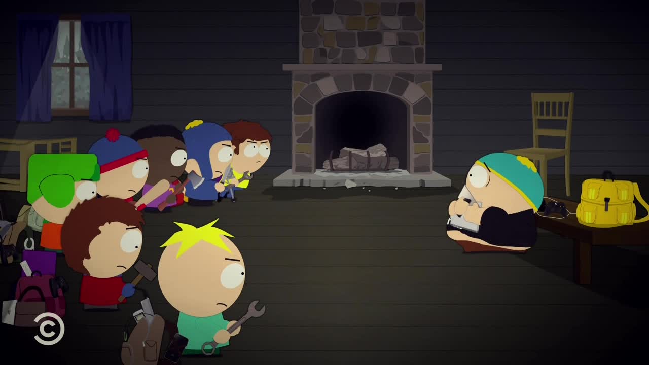 A group of boys, some holding tools, stare at Cartman, who sits hunched over, clutching a small object. The scene unfolds in a cabin, a setting familiar from the animated series on Comedy Central.
