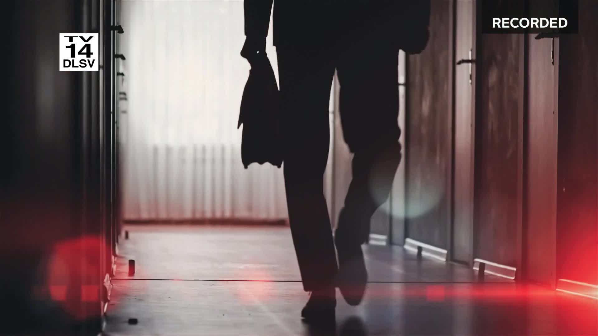 A silhouetted figure walks down a long hallway, a briefcase clutched in one hand. The "Recorded" stamp in the corner suggests this scene comes from a Court TV broadcast in the United States.
