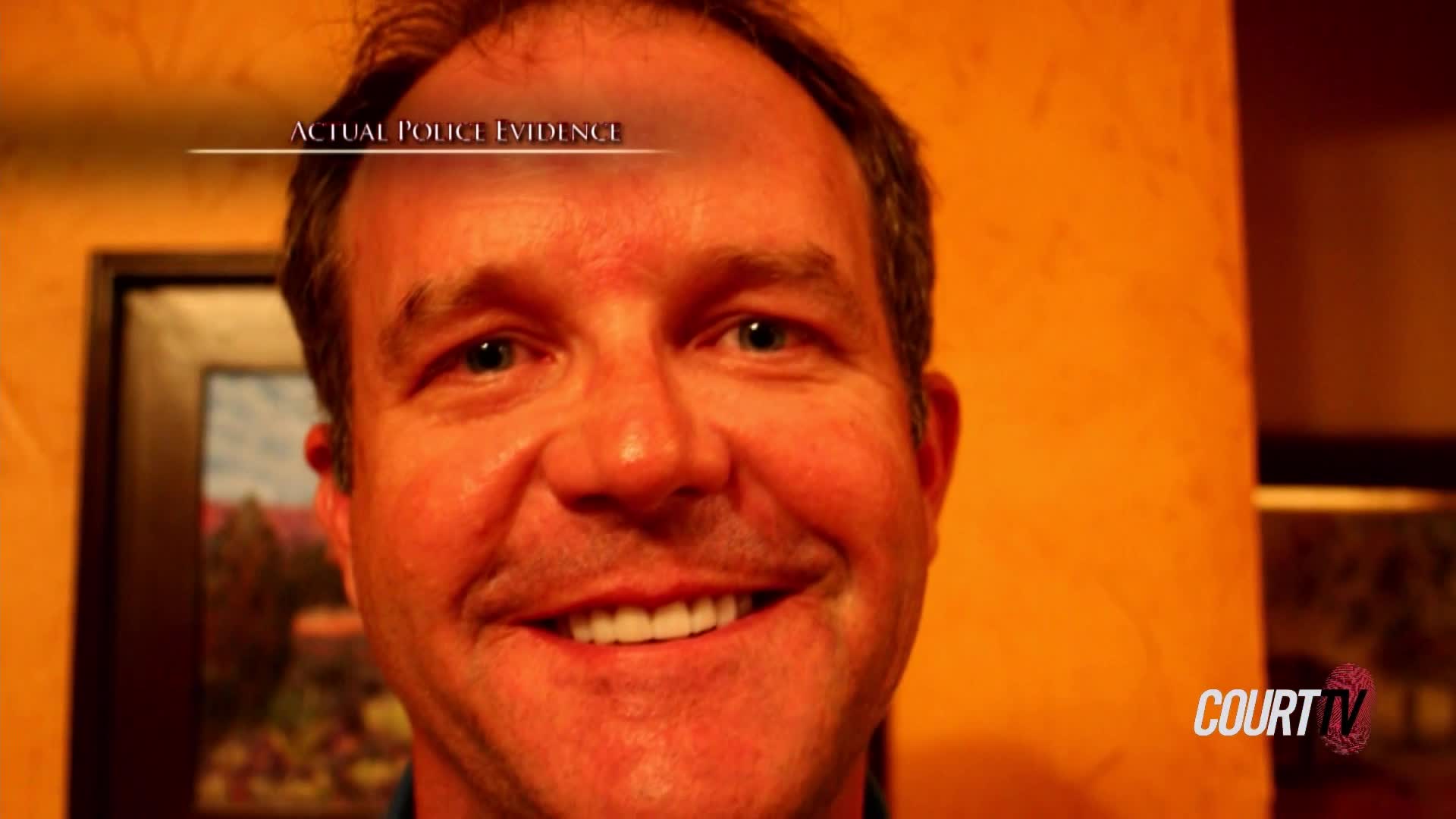 A man with light eyes and a wide smile fills the frame, his face illuminated by warm, orange light. The Court TV logo is visible in the bottom right corner, and the words "ACTUAL POLICE EVIDENCE" are at the top.
