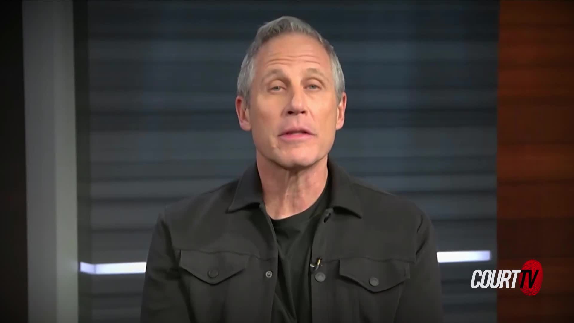 A man with graying hair, wearing a black jacket over a dark shirt, speaks directly to the camera. The Court TV logo appears in the lower right corner.