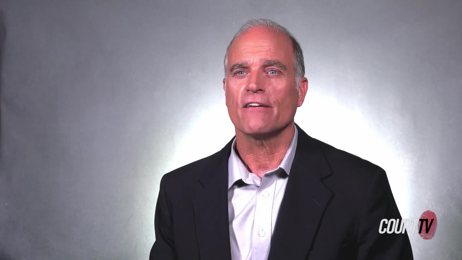 A man in a dark suit and light shirt speaks directly to the camera. The Court TV logo appears in the lower right corner.