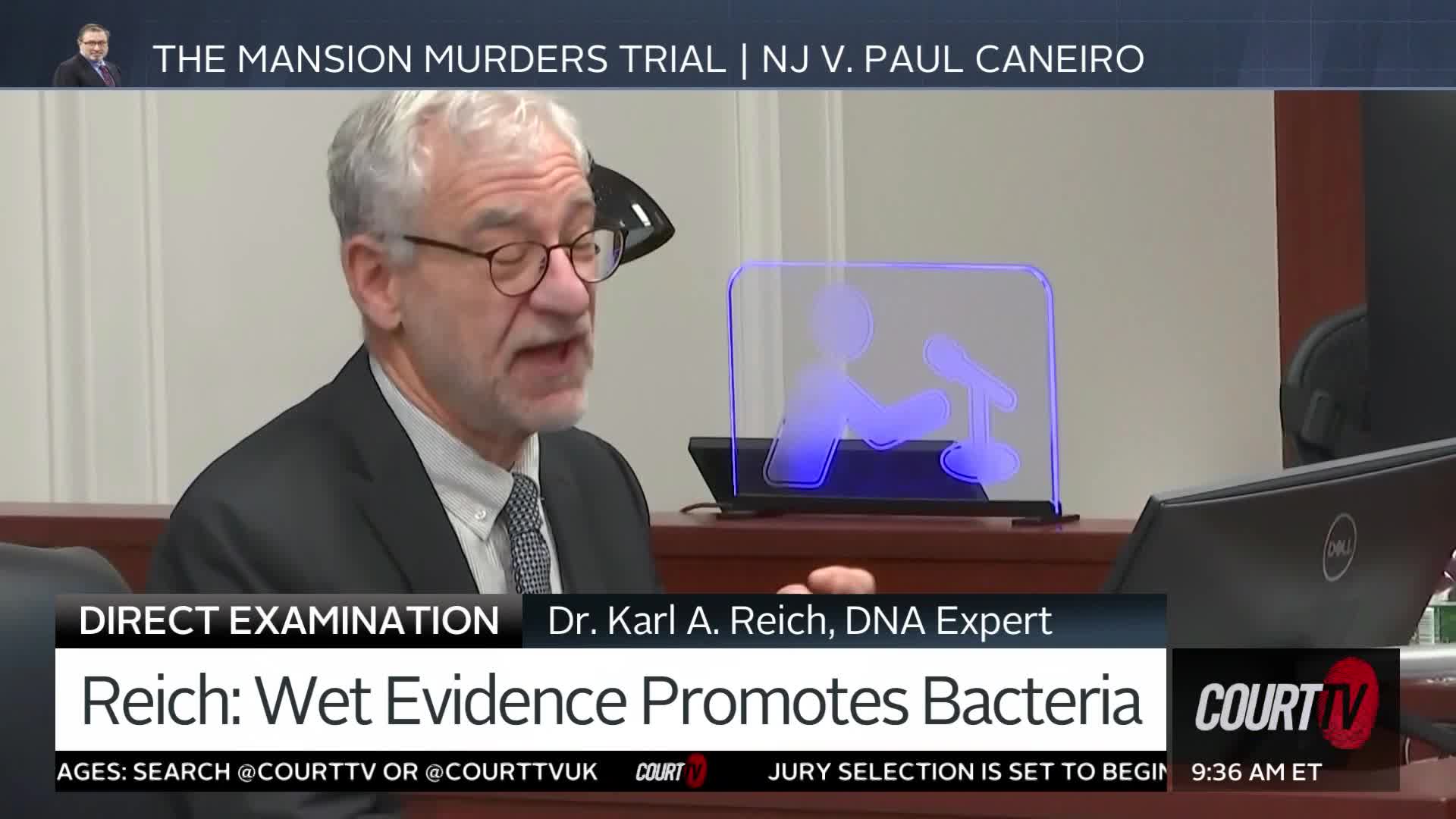 A man with glasses and gray hair is speaking at a podium. A graphic on the screen identifies him as Dr. Karl A. Reich, a DNA Expert, in the NJ v. Paul Caineiro trial.