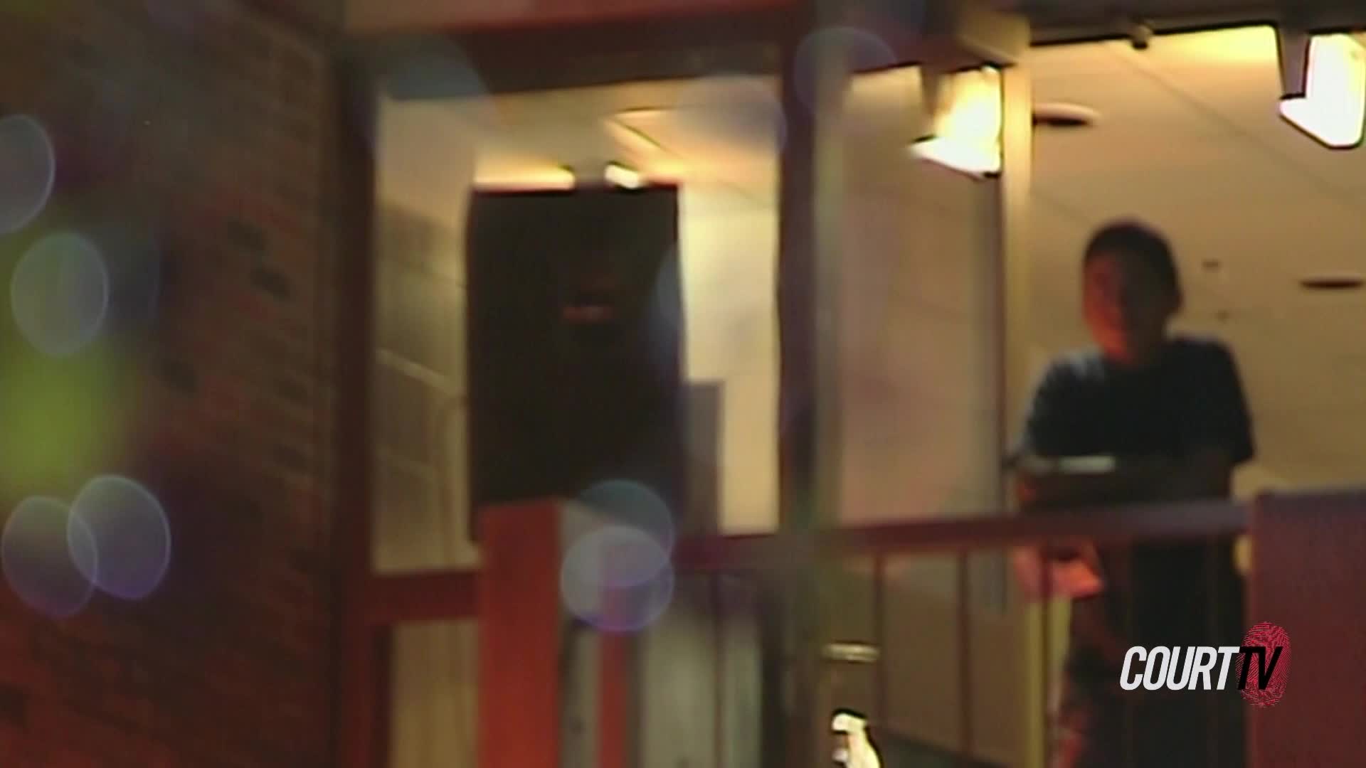 A person stands in a doorway, illuminated by overhead lights. The scene is captured with a Court TV watermark.