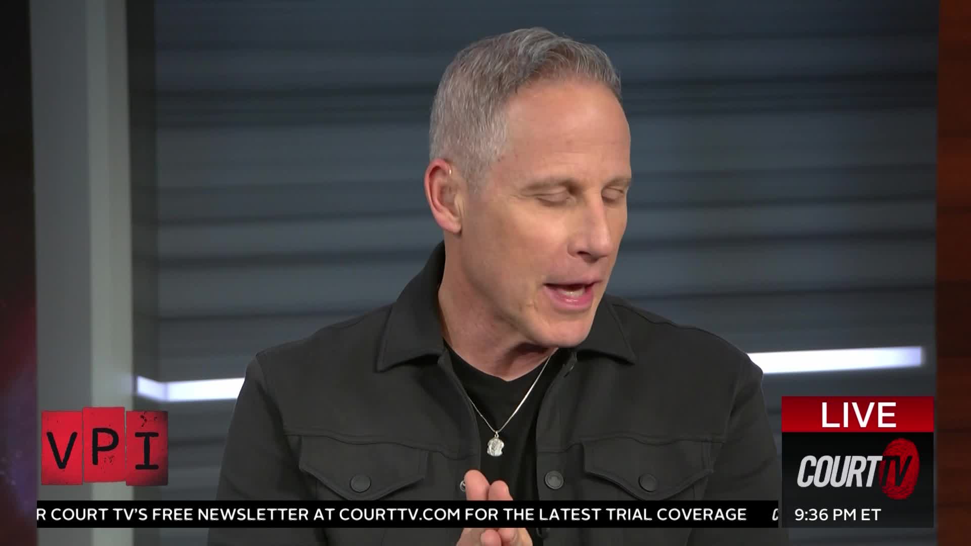 A man in a black jacket speaks into a microphone, his hands clasped together. A "LIVE COURT TV" graphic appears in the lower right corner.