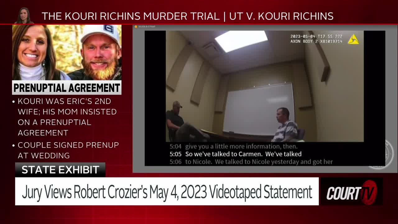 Two men sit across a table in a sterile room, one facing a camera. The screen displays text about a prenuptial agreement and the Kouri Richins murder trial.