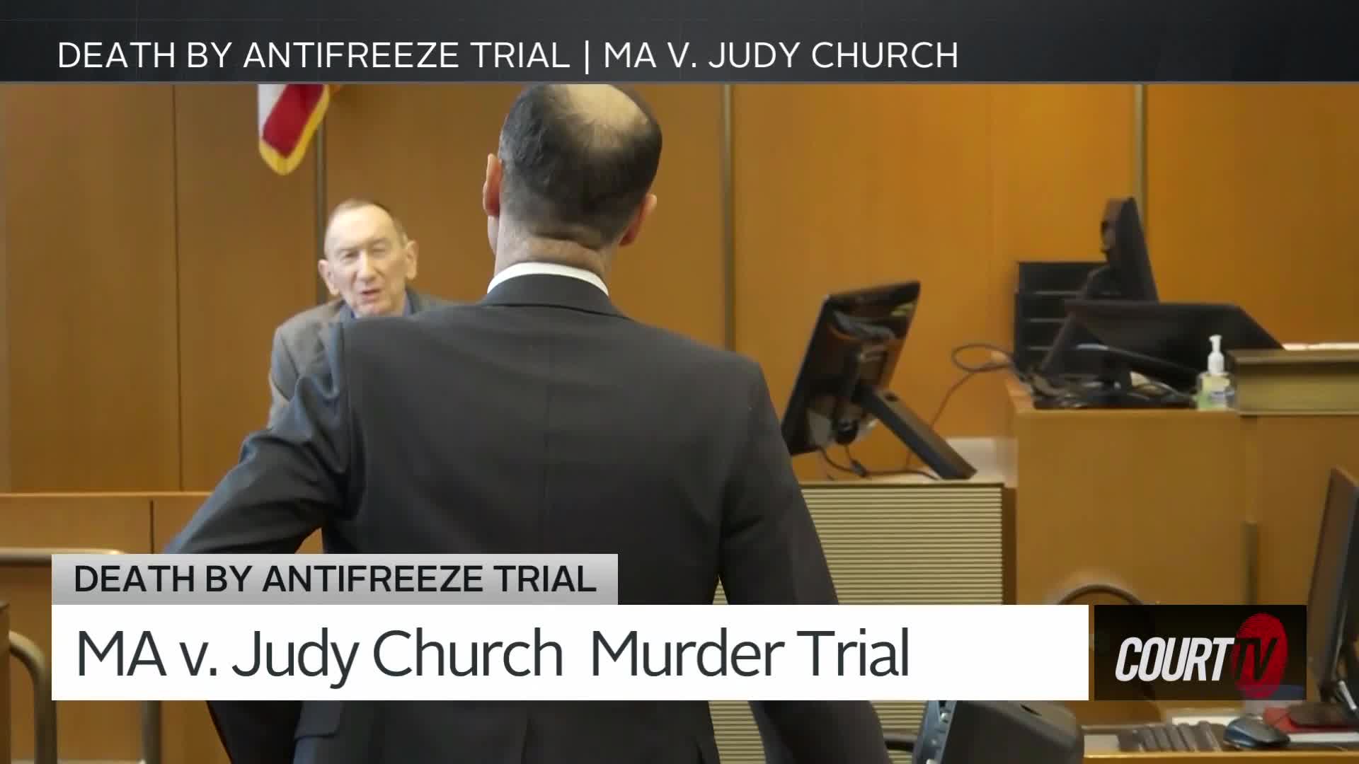 A man in a dark suit stands with his back to me, facing a witness. The witness, an older man with glasses, speaks animatedly from behind a wooden railing. The scene is a courtroom, with the Court TV logo visible.