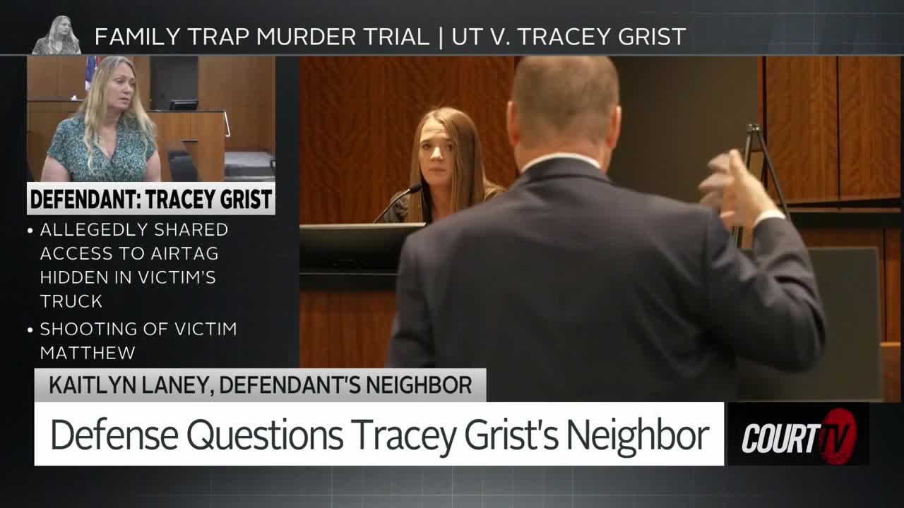 A woman in a suit stands with her back to me, gesturing with her hands as she speaks to someone seated behind a bench. A smaller screen in the corner shows a woman with blonde hair, identified as the defendant, Tracey Grist, listening intently.