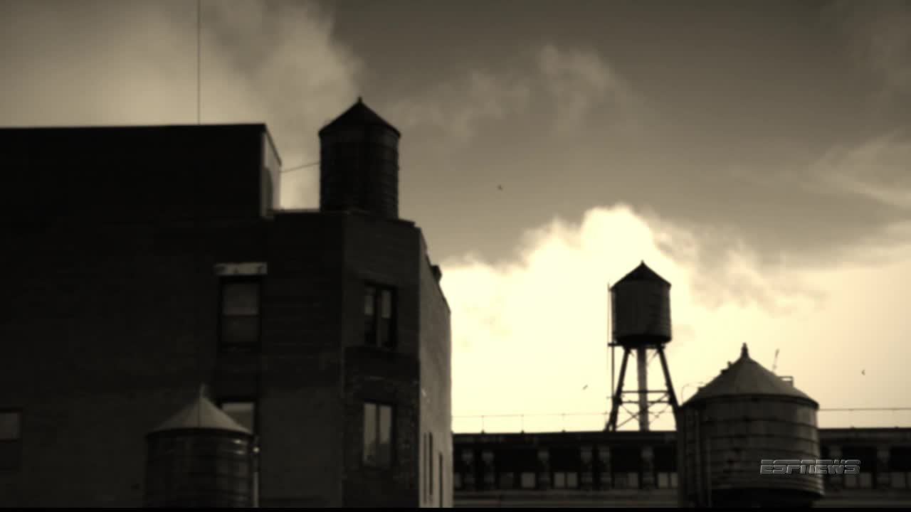 Rooftop water towers stand silhouetted against a cloudy sky. The ESPNews logo is visible in the lower right corner.
