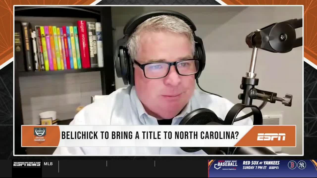 A man wearing glasses and a headset is speaking into a microphone, with the ESPN logo and the question "Belichick to bring a title to North Carolina?" displayed on the screen. Below, the ESPNews banner shows a baseball game is scheduled for Sunday.

