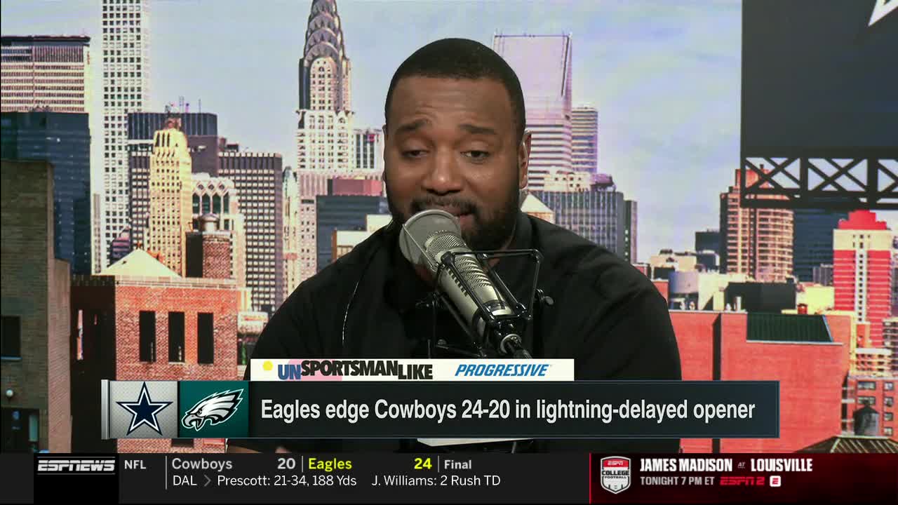A man with a beard speaks into a microphone, the ESPNews logo visible below. Behind him, a cityscape provides the backdrop for the sports commentary.

